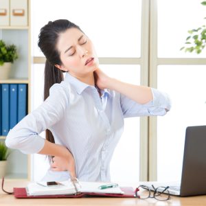 Young asian business woman with pain in neck in office